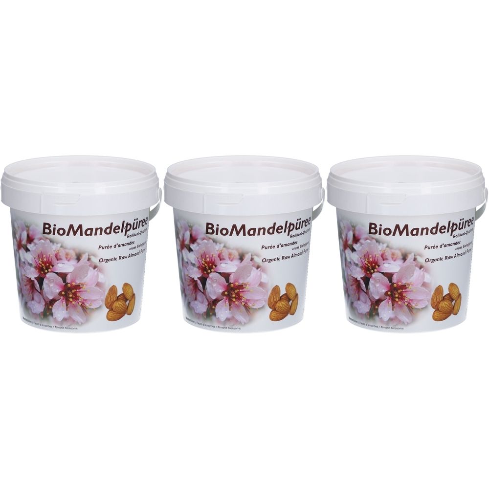 Trois pots de purée d'amandes bio, décorés de fleurs d'amandier et d'amandes.