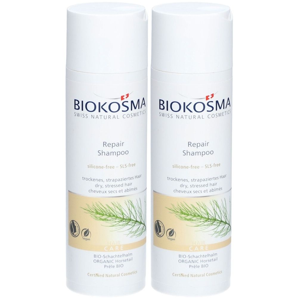 Deux flacons de shampooing blancs avec étiquettes. Inscription: BIOKOSMA, Repair Shampoo. Pour cheveux secs et abîmés.