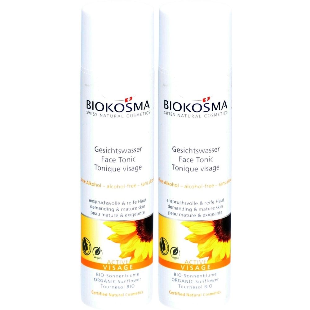 Twee witte flessen met etiketten. Opschrift: BIOKOSMA, Gesichtswasser, Face Tonic, Tonique visage. Afbeelding van een zonnebloem.