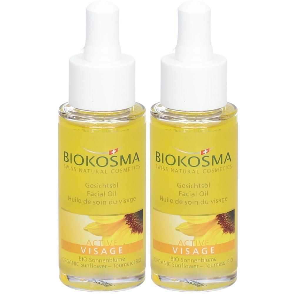 Twee flessen gezichtsolie met etiket. Opschrift: Biokosma, Active Visage, zonnebloem. Gele vloeistof, witte doppen.