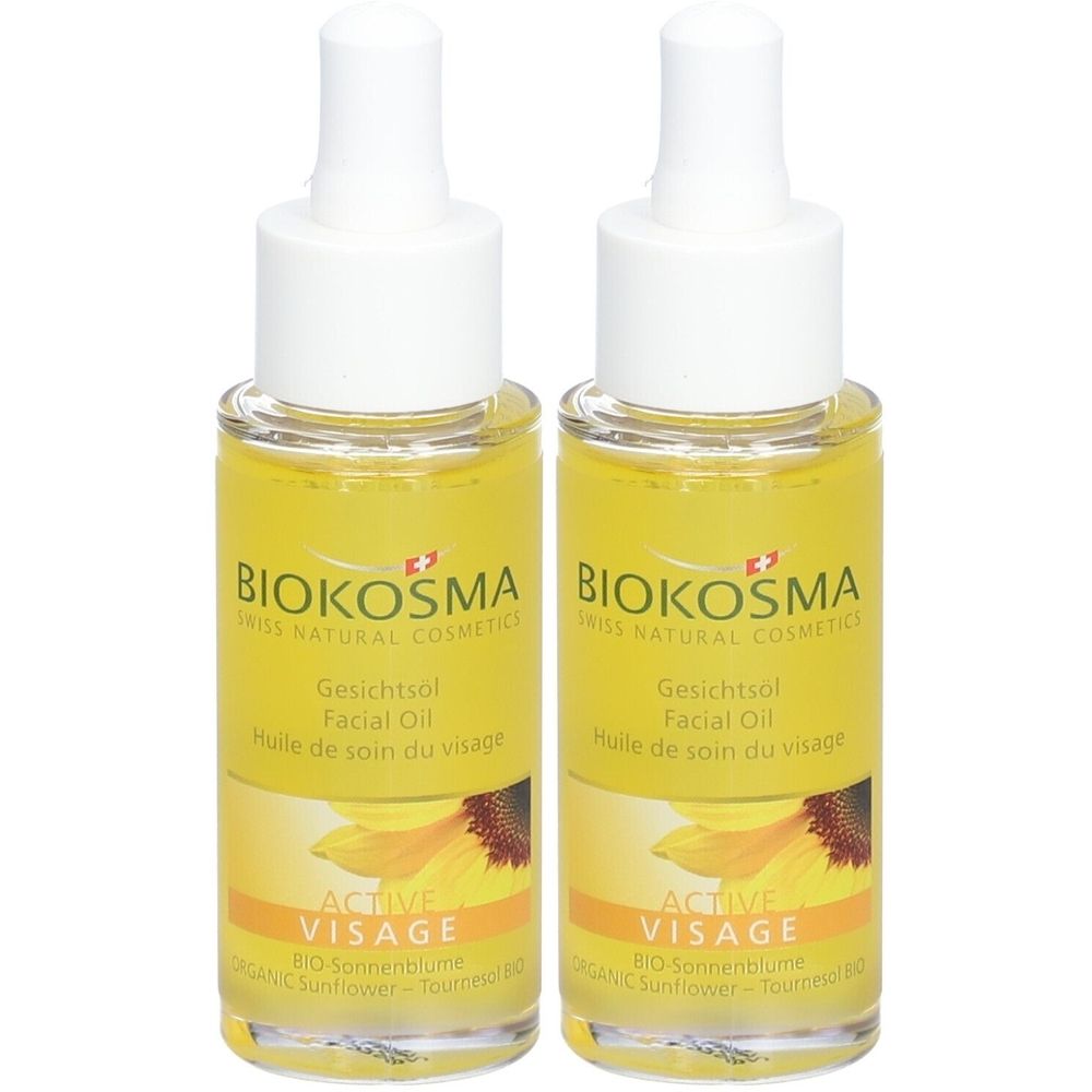 Deux flacons d'huile pour le visage avec étiquette. Inscription : Biokosma, Active Visage, tournesol. Liquide jaune, bouchons blancs.