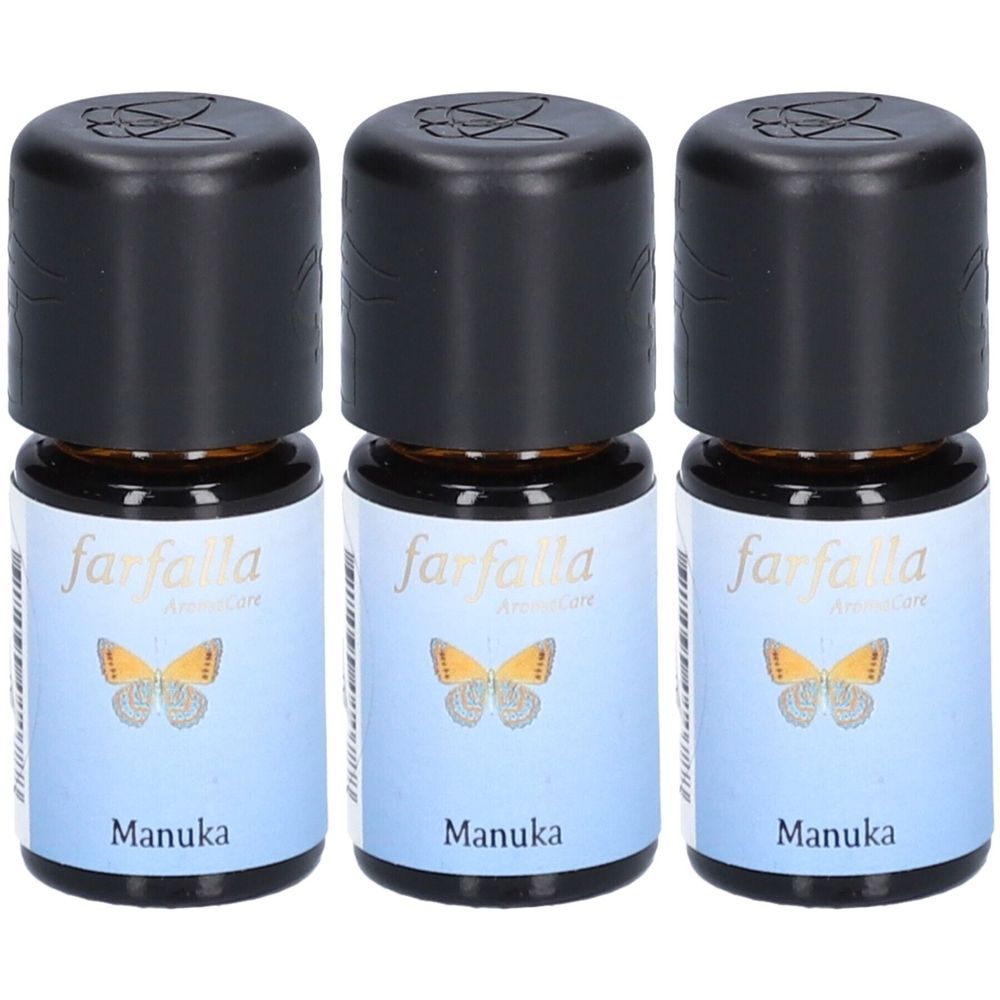 Drie kleine flesjes met zwarte dop. Labels met "farfalla", een vlinder en "Manuka".
