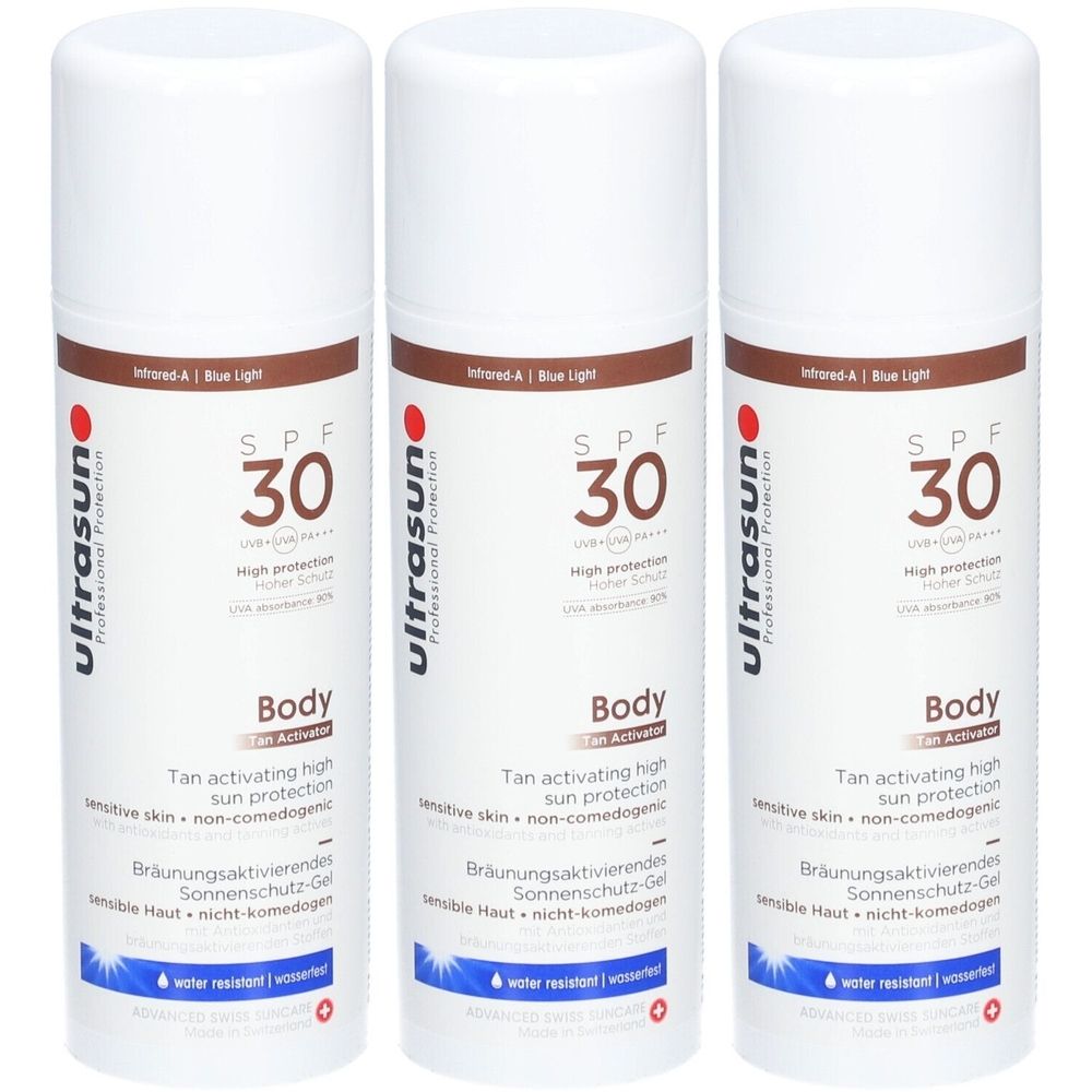 Drie witte spuitbussen met bruine band. Opschrift: SPF 30, Body, Tan Activator, ultrasun. Waterbestendig.