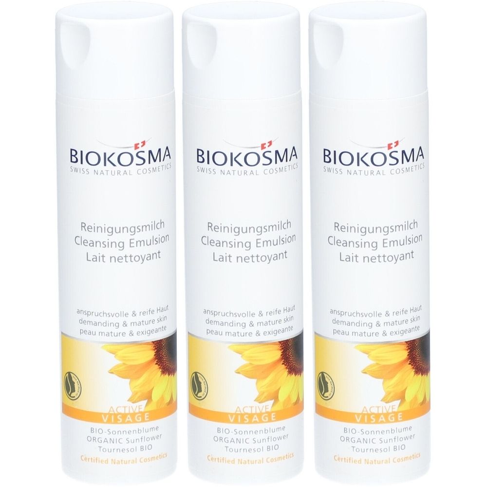 Drie witte flessen met etiketten. Opschrift: BIOKOSMA, Reinigungsmilch, Cleansing Emulsion, Lait nettoyant. Met zonnebloem illustratie.
