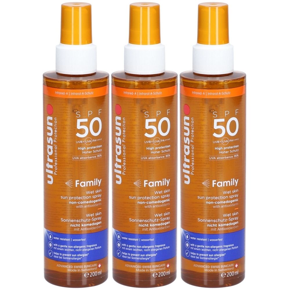 Drie spuitflessen met oranje doppen. De etiketten tonen "SPF 50" en "Family". 