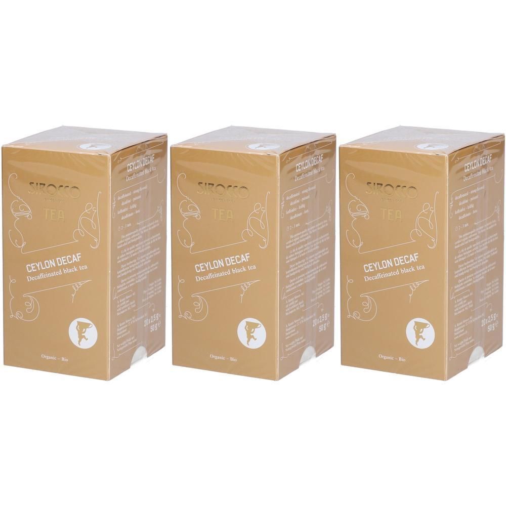 Drie goudkleurige dozen met opschrift Ceylon Decaf. Logo en tekst op de voorkant. Verpakking met transparante folie.