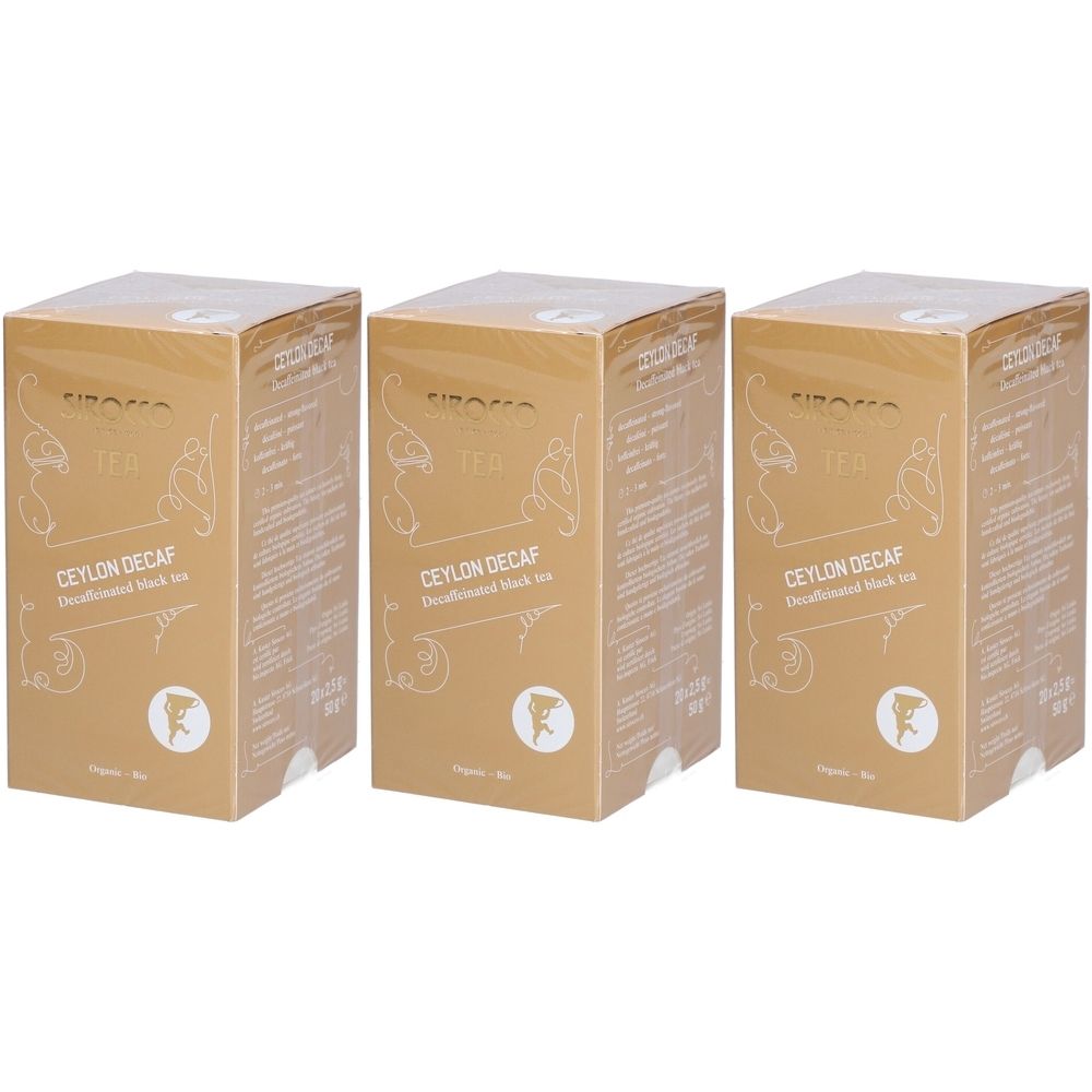 Trois boîtes dorées avec l'inscription Ceylon Decaf. Logo et texte sur le devant. Emballage avec film transparent.