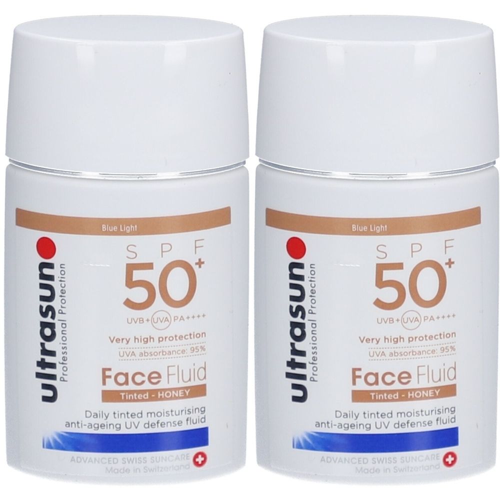 Twee witte flacons met witte doppen. Opschrift: ultrasun, SPF 50+, Face Fluid, getint, Honey. Anti-aging UV-bescherming.