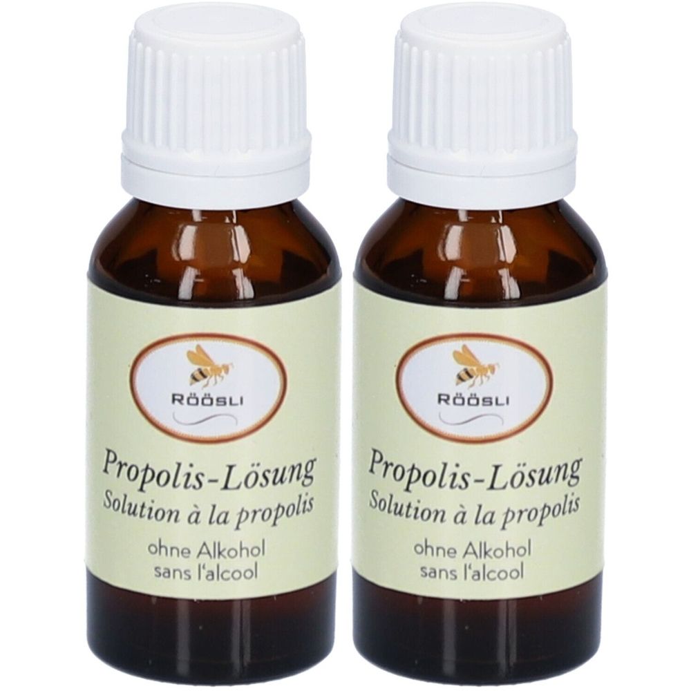 Deux flacons en verre brun avec bouchons blancs. Étiquettes avec texte: RÖÖSLI, Solution à la propolis, sans alcool. Image d'une abeille.