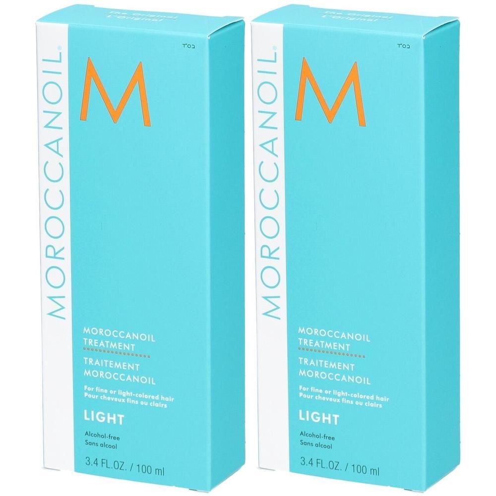 Twee Moroccanoil Treatment Light flessen in turquoise verpakking met oranje M-logo.