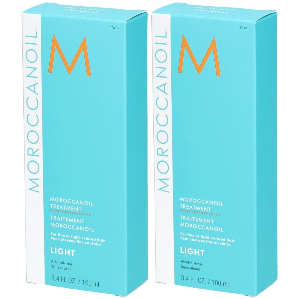 Deux bouteilles de Moroccanoil Treatment Light dans un emballage turquoise avec logo M orange.