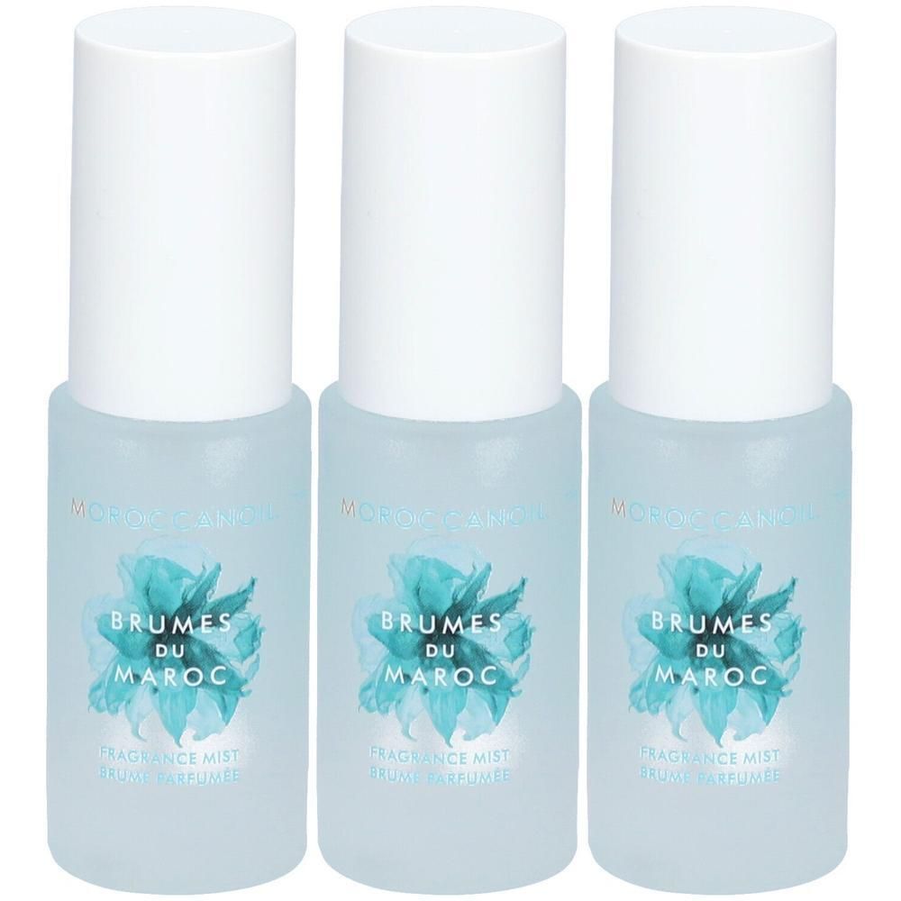 Drie flacons Moroccanoil Brumes du Maroc met witte dop en blauw etiket.