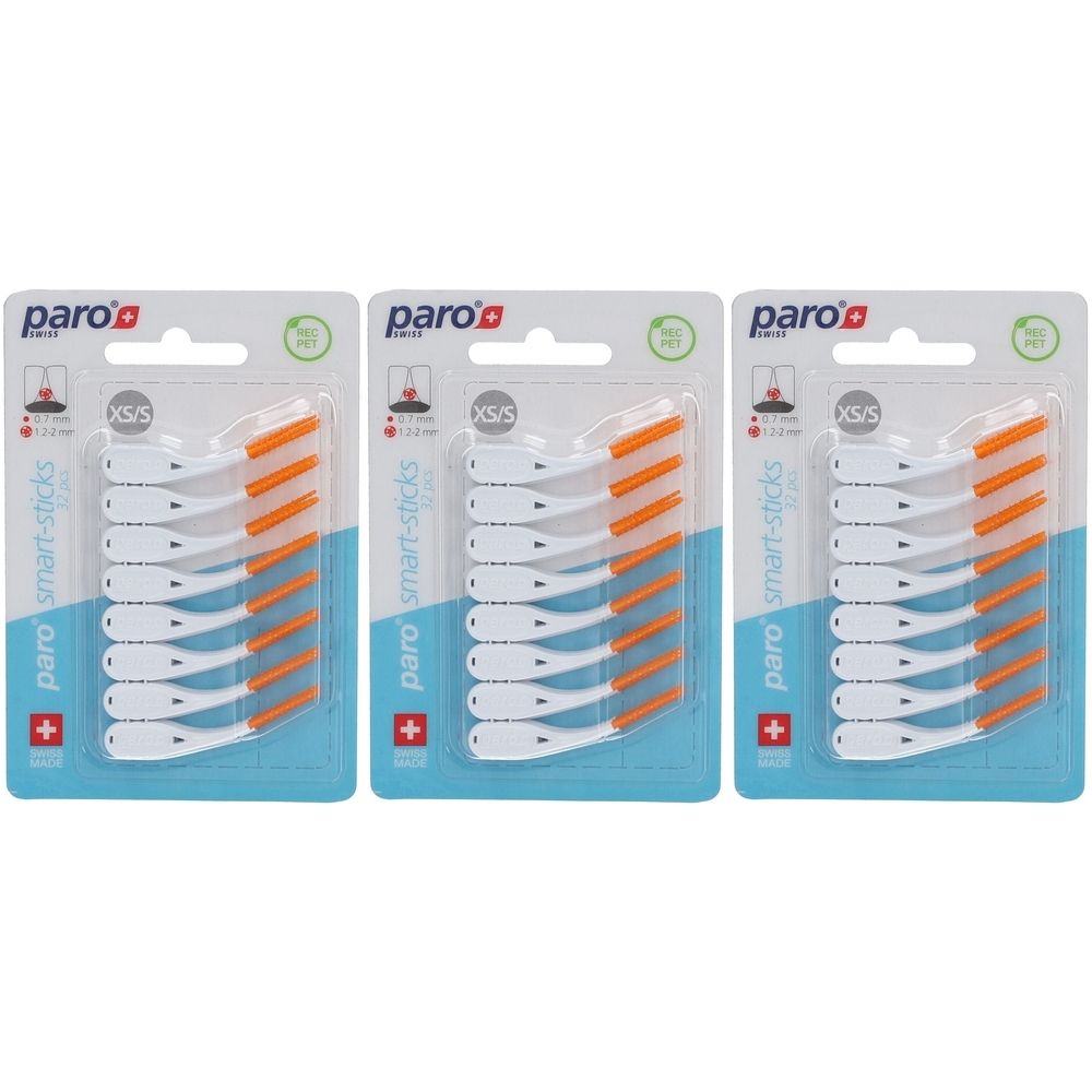 Trois emballages de Paro Smart-Sticks XS/S. Chaque emballage contient des brossettes interdentaires blanches et oranges. Drapeau suisse et logo.
