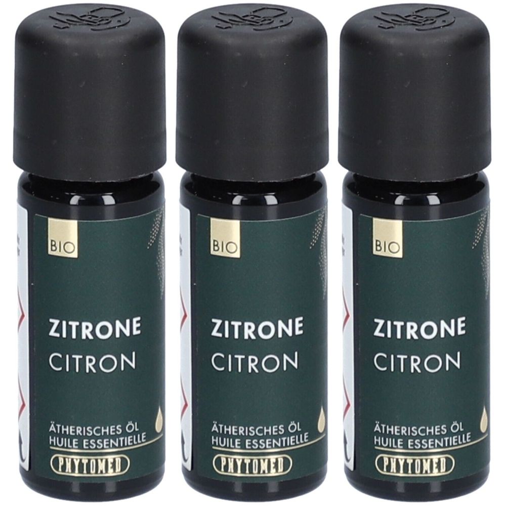 Trois petites bouteilles avec bouchons noirs. Les étiquettes indiquent "Zitrone" et "Huile essentielle". Le logo PHYTOMED est visible.
