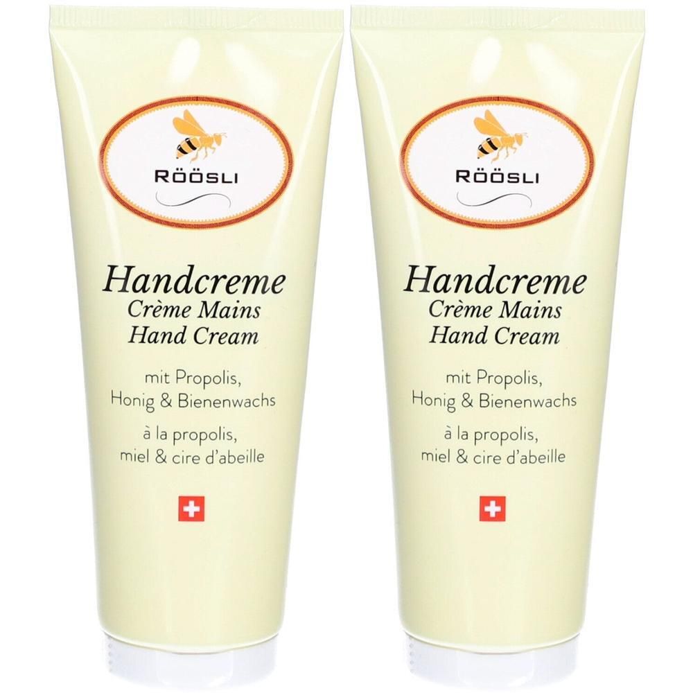 Twee tubes handcrème. Opschrift: Handcreme, Crème Mains, Hand Cream. Met propolis, honing & bijenwas. Zwitsers kruis.