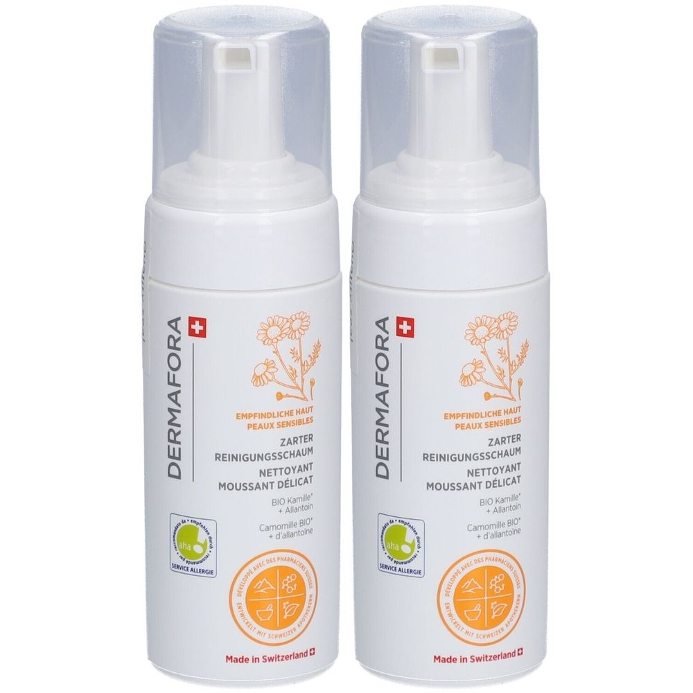 Deux flacons blancs avec vaporisateur. Inscription: DERMAFORA, Mousse nettoyante délicate. Croix suisse. Logos et texte orange et vert.