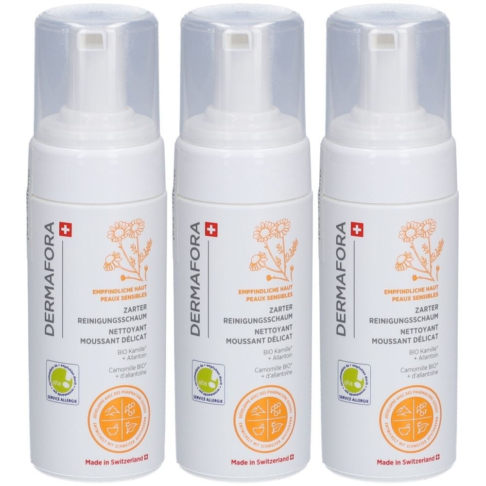 Drie witte flessen met sproeikop. Opschrift: DERMAFORA, ZARTER REINIGUNGSSCHAUM, Zwitsers kruis. Logo en tekst in meerdere talen.