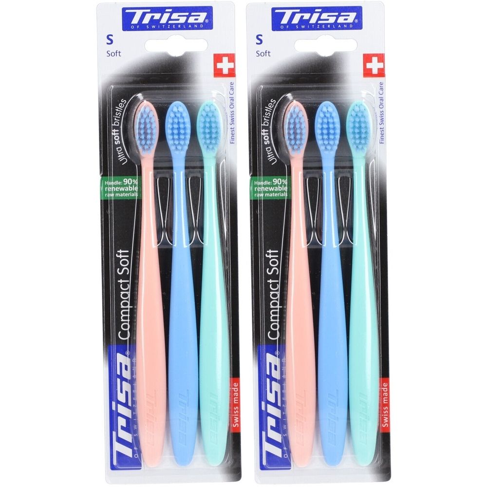 Twee verpakkingen Trisa Compact Soft tandenborstels. Elke verpakking bevat drie roze, blauwe en groene tandenborstels.