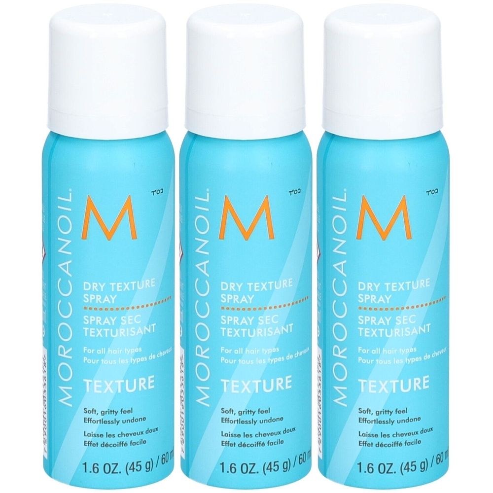 Trois flacons de Moroccanoil Dry Texture Spray turquoise avec bouchon blanc. Texte : DRY TEXTURE SPRAY.