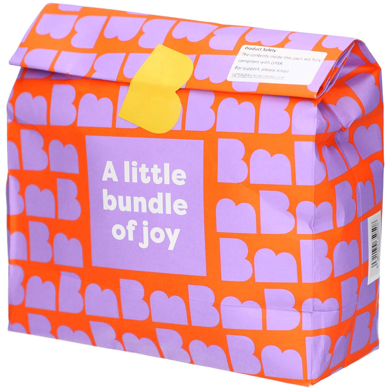 Verpakking met oranje patroon en paarse letters. Tekst: A little bundle of joy. Gele sluiting.