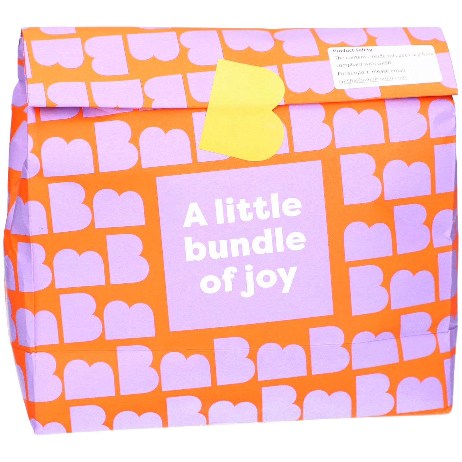 Verpakking met oranje patroon en paarse letters. Tekst: A little bundle of joy. Gele sluiting.