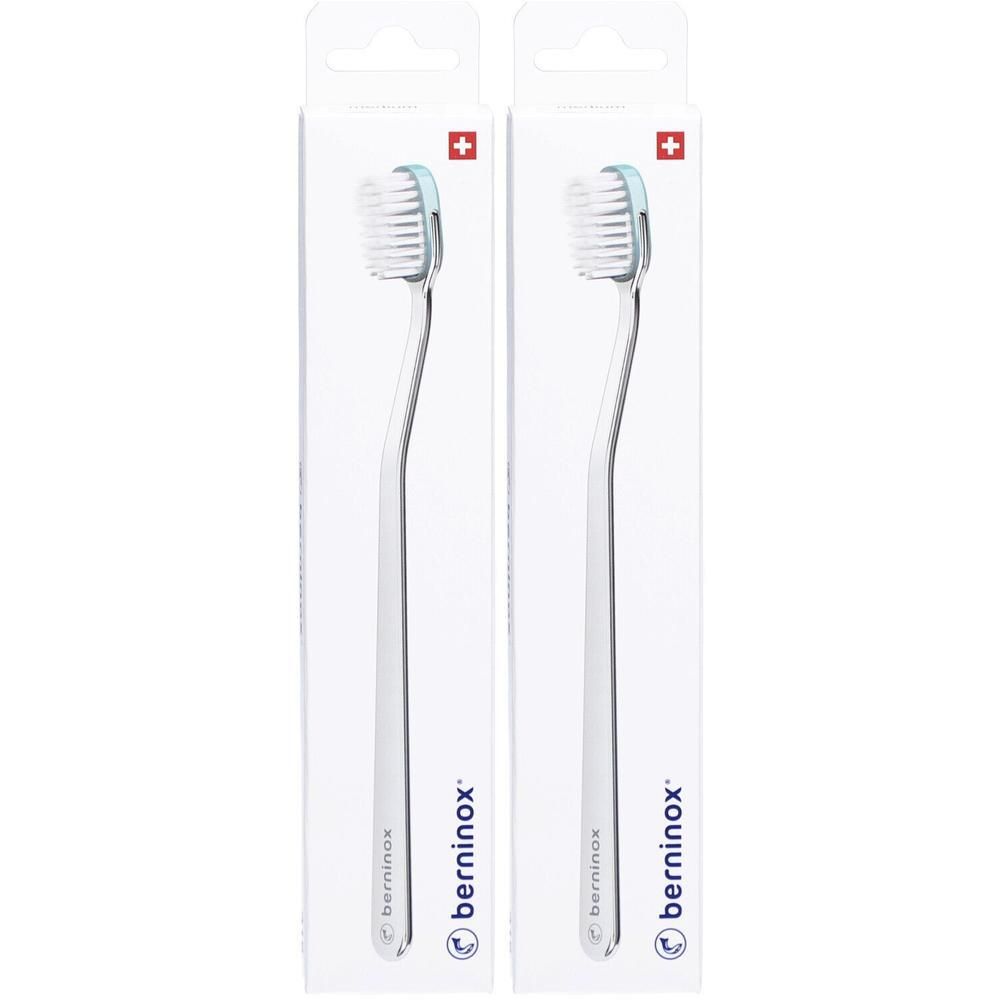 Twee tandenborstels in verpakking. Ijsgroene borstelharen, witte steel, Zwitsers kruis. Merk: berninox.