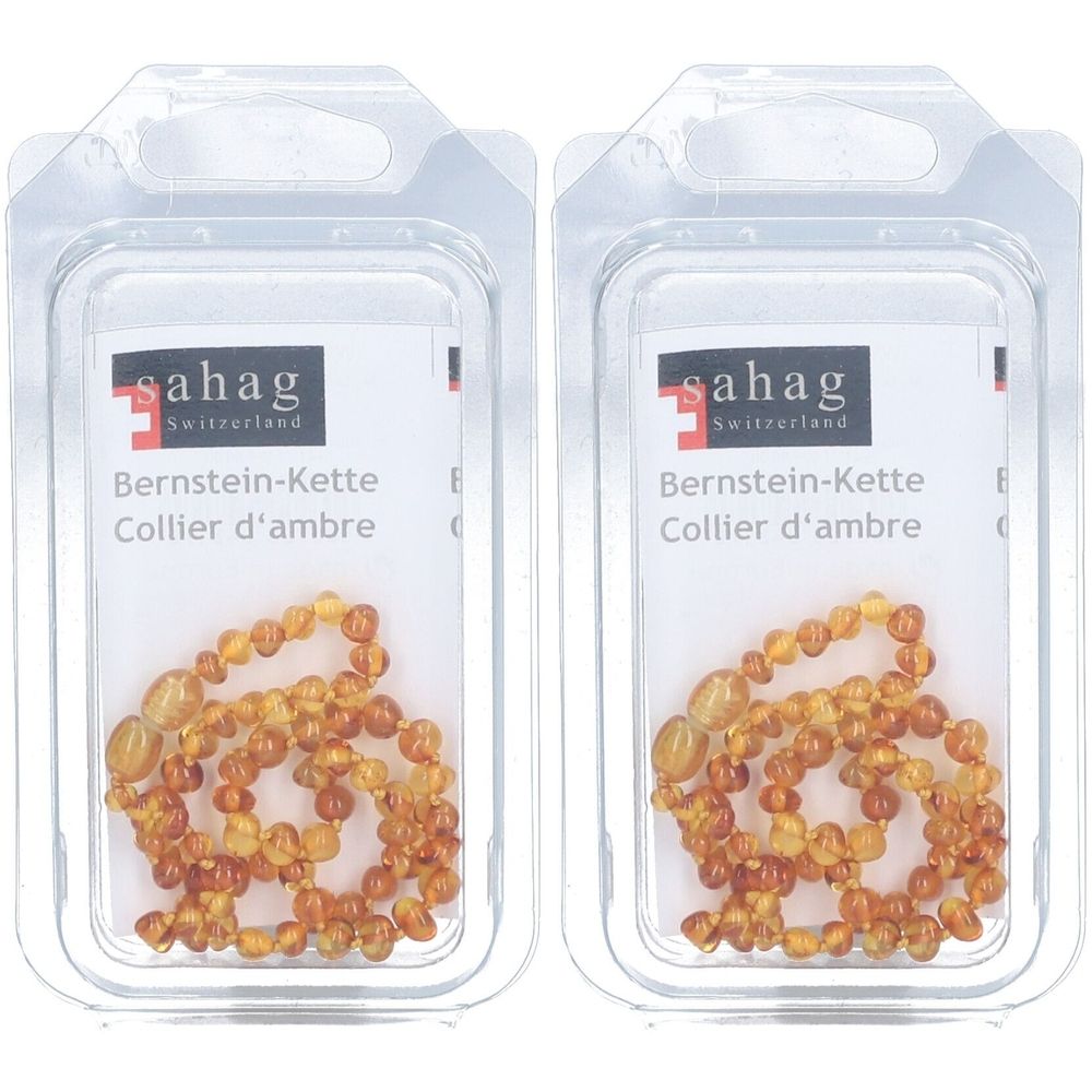 Twee babykettingen van natuurlijke barnsteen in een transparante verpakking. Opschrift: sahag, Bernstein-Kette, Collier d'ambre.