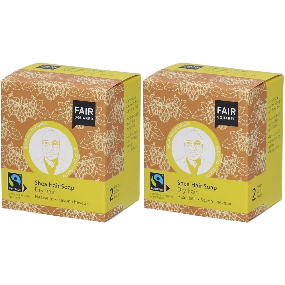 Twee vierkante dozen met FAIR SQUARED logo. Opschrift: Shea Hair Soap, Dry hair. Fairtrade-keurmerk. Geelbruin ontwerp.