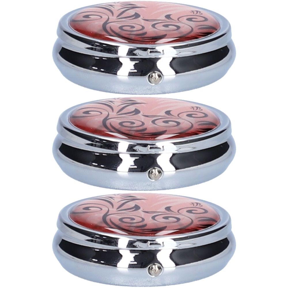 Drie ronde pillendoosjes met bloemmotief op rode achtergrond. Zilverkleurige metalen behuizing met kleine sluiting.
