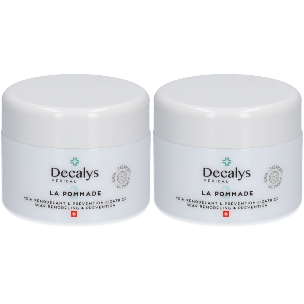 Deux pots blancs avec couvercles. Sur le devant, "Decalys Medical LA POMMADE". Texte en dessous : "Soin remodelant & prevention cicatrice".