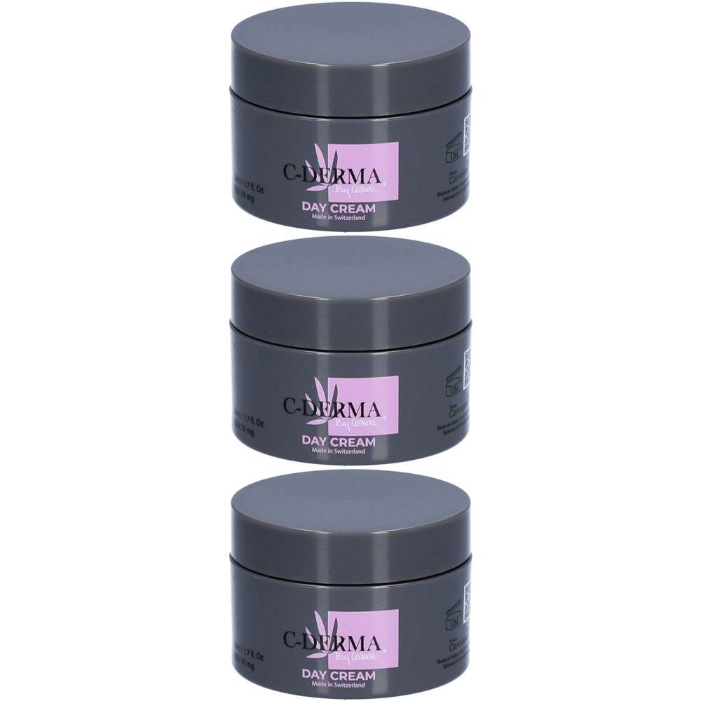 Trois pots gris avec couvercles. Chaque pot porte une étiquette rectangulaire avec l'inscription "C-DERMA DAY CREAM".