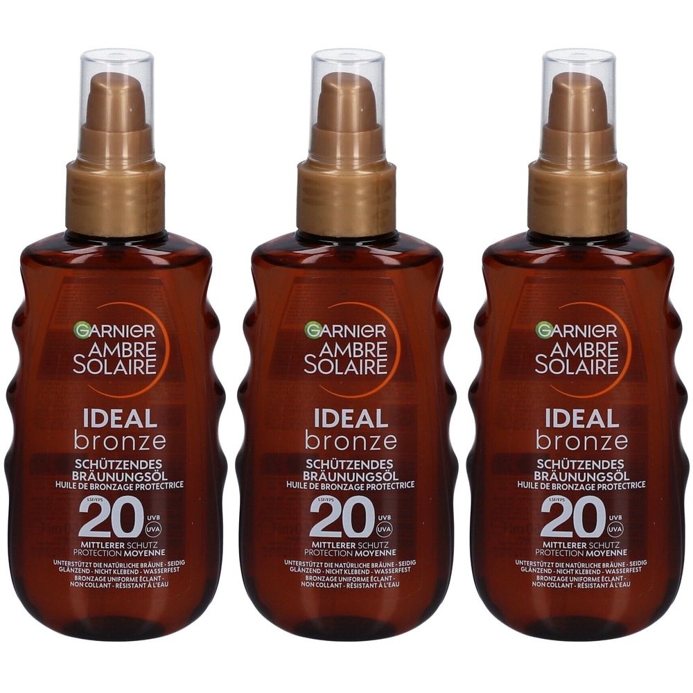 Drie bruine sprayflessen. Op elke fles staat "GARNIER AMBRE SOLAIRE IDEAL bronze" en "20".