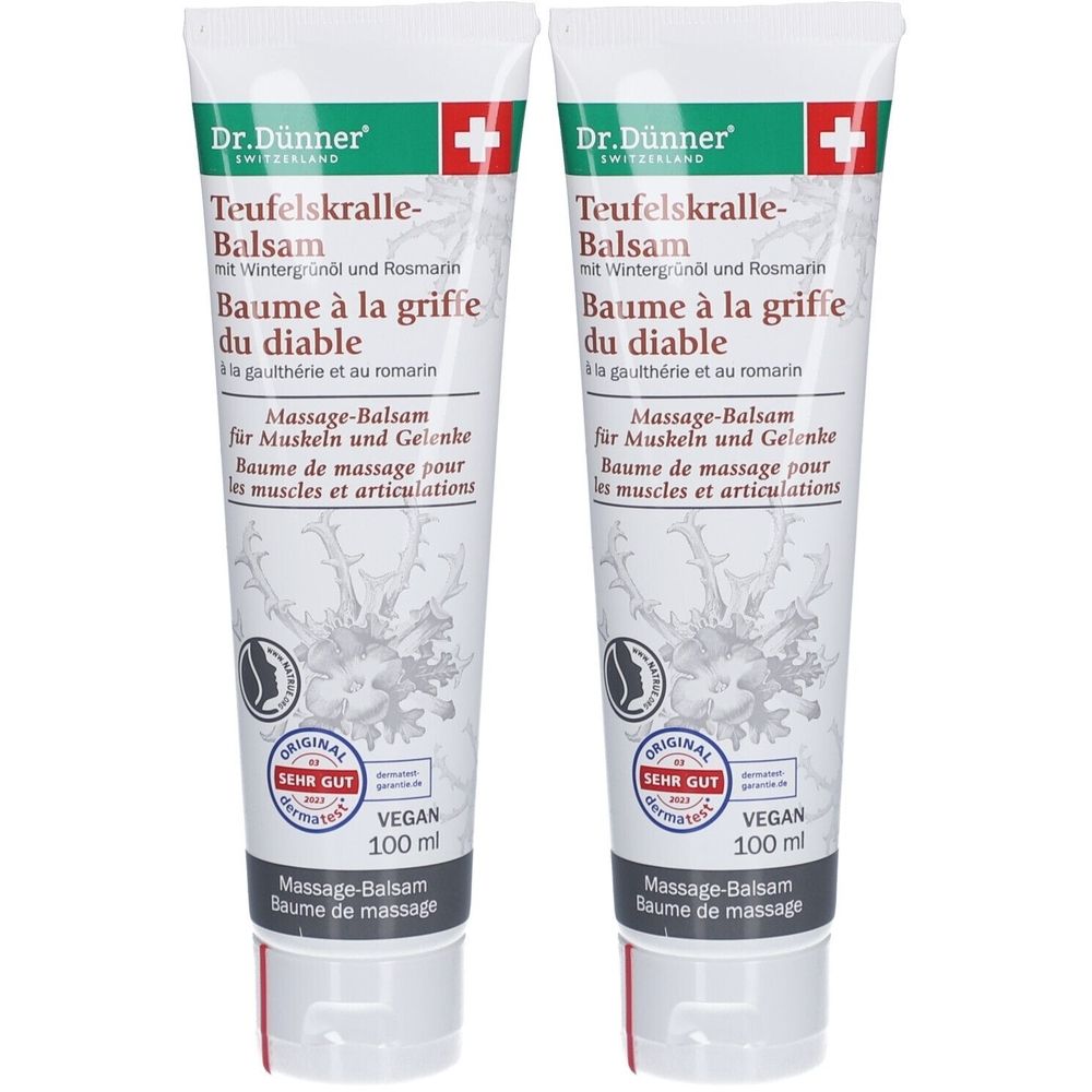 Twee tubes balsem. Opschrift: Dr. Dünner, Duivelsklauw balsem, Massagebalsem. Met Zwitsers kruis en Vegan-label.