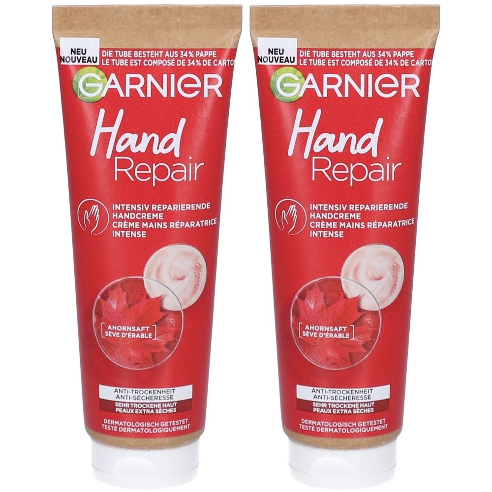 Twee tubes handcrème. Rode tubes met witte dop. Opschrift: GARNIER Hand Repair. Tekst in het Duits en Frans. Met ahornsap.