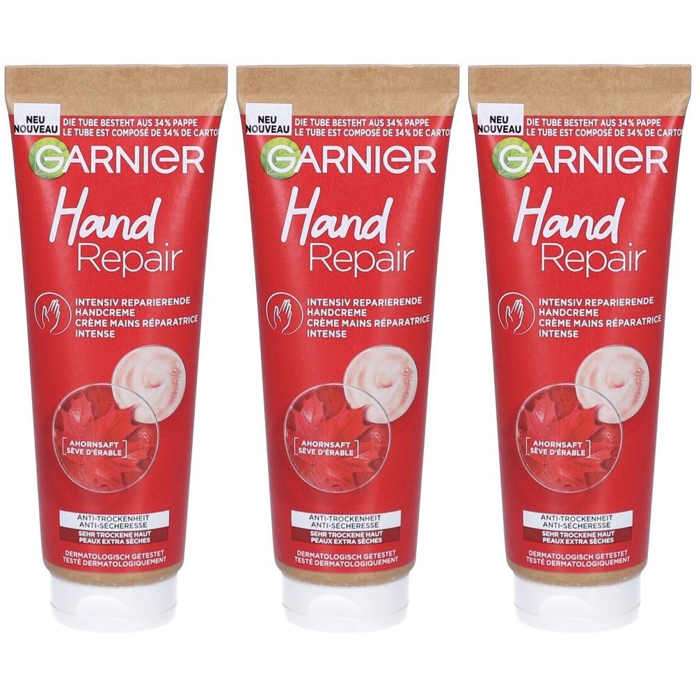 Drie tubes handcrème. Rode tubes met witte dop. Opschrift: Garnier Hand Repair. Tekst in het Duits en Frans.