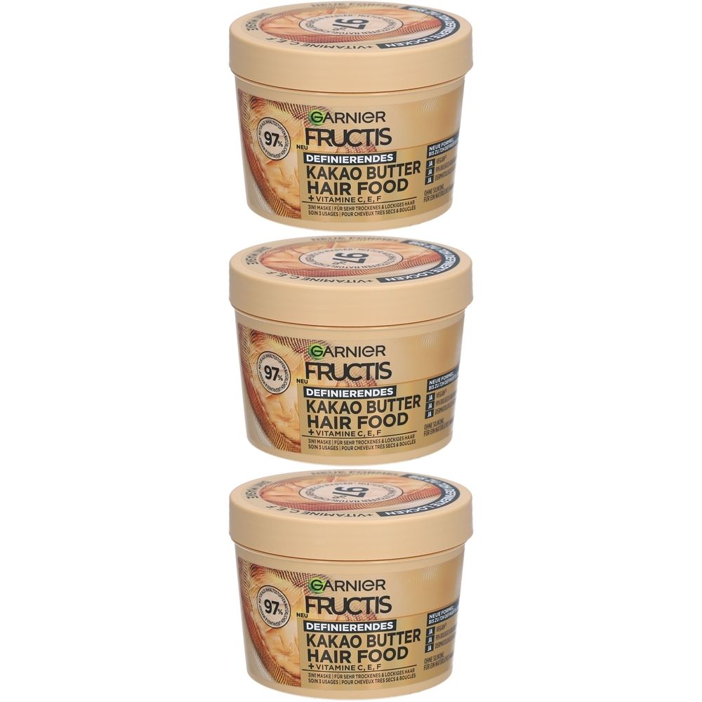 Drie crèmekleurige potten met deksels. Op elke pot staat "GARNIER FRUCTIS KAKAO BUTTER HAIR FOOD".