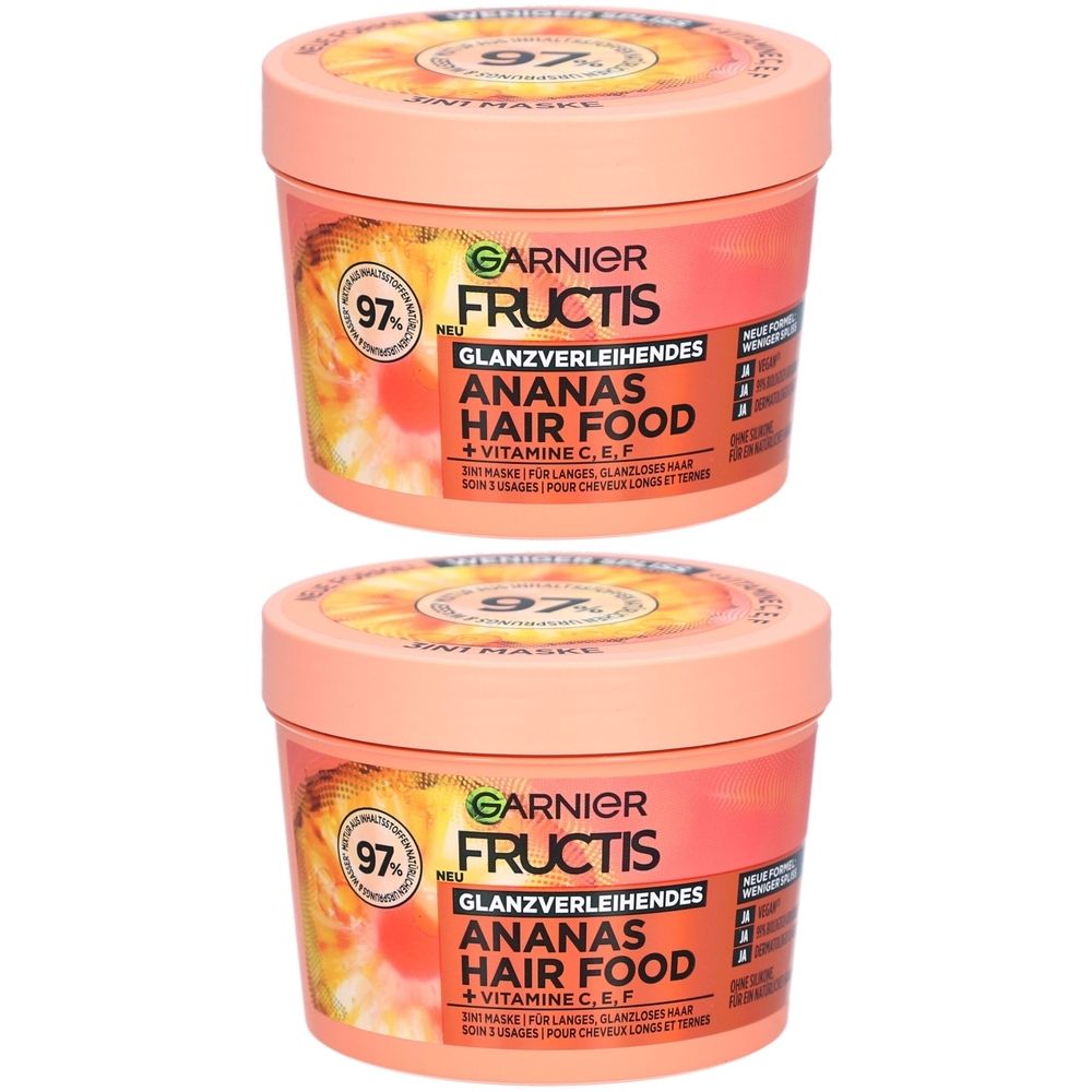 Twee roze potten met deksels. Opschrift: Garnier Fructis Ananas Hair Food. Met 97% ingrediënten van natuurlijke oorsprong.