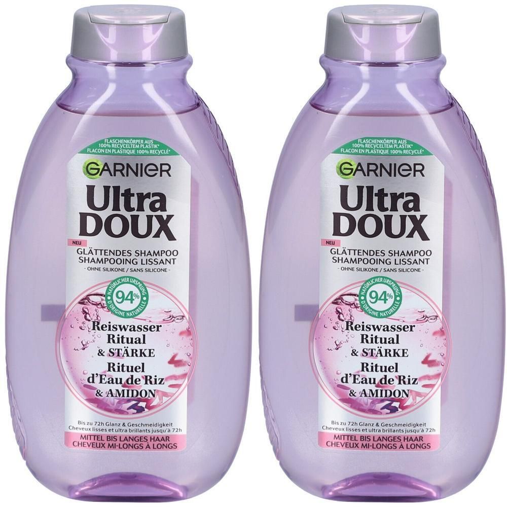 Twee flessen Garnier Ultra Doux shampoo. Paarse flessen met zilveren dop. Tekst: Rijstwater Ritual & Sterkte. 94% ingrediënten van natuurlijke oorsprong.