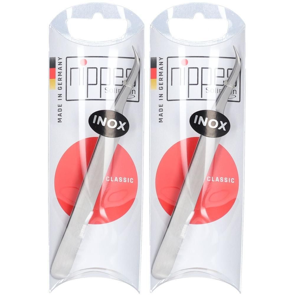 Deux pinces à tiques incurvées en acier inoxydable dans un emballage transparent. Marque Nippes, logo INOX, cercle rouge.