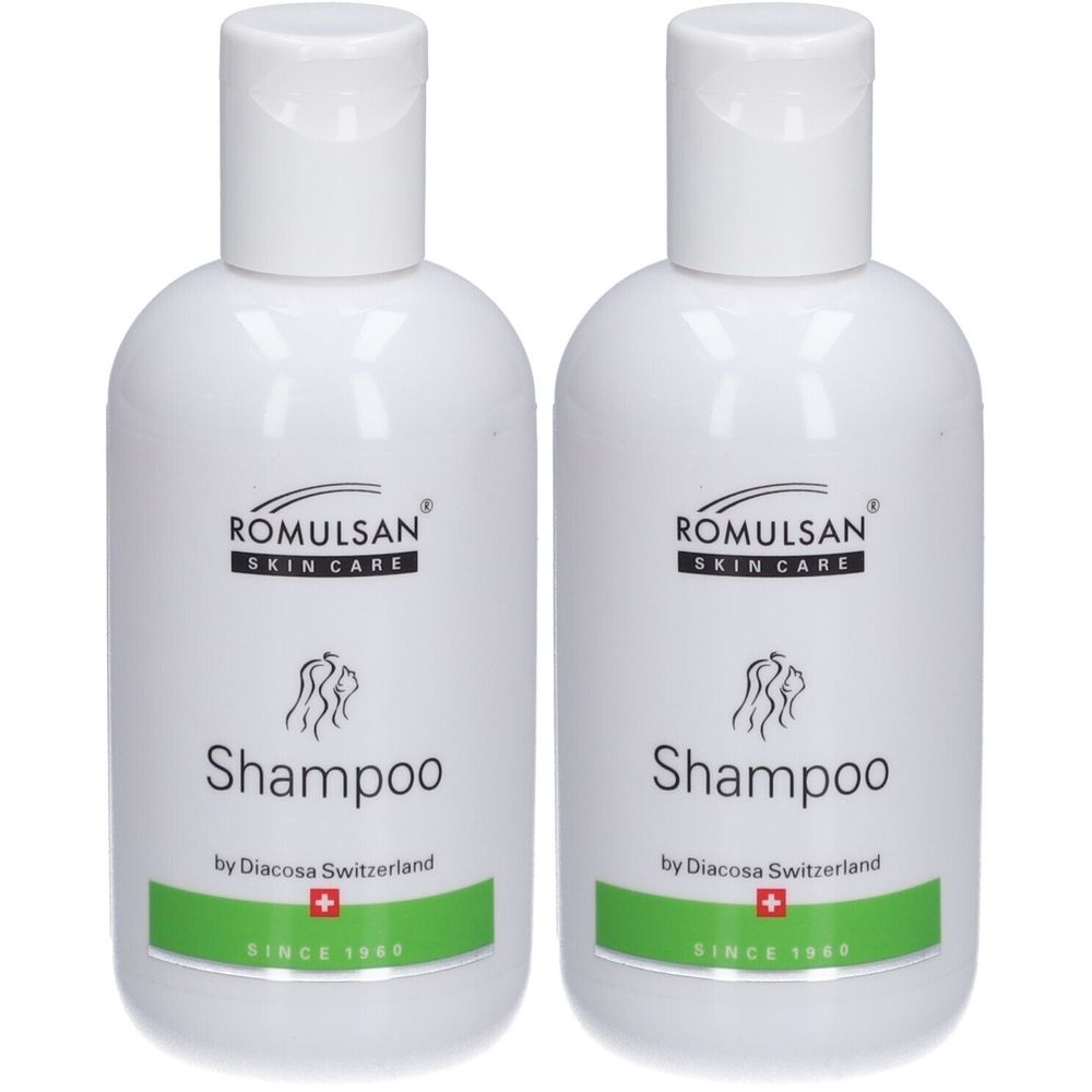 Twee witte shampoo flacons met klapdeksel. Opschrift: ROMULSAN SKIN CARE, Shampoo, by Diacosa Switzerland, Zwitsers kruis, SINCE 1969.