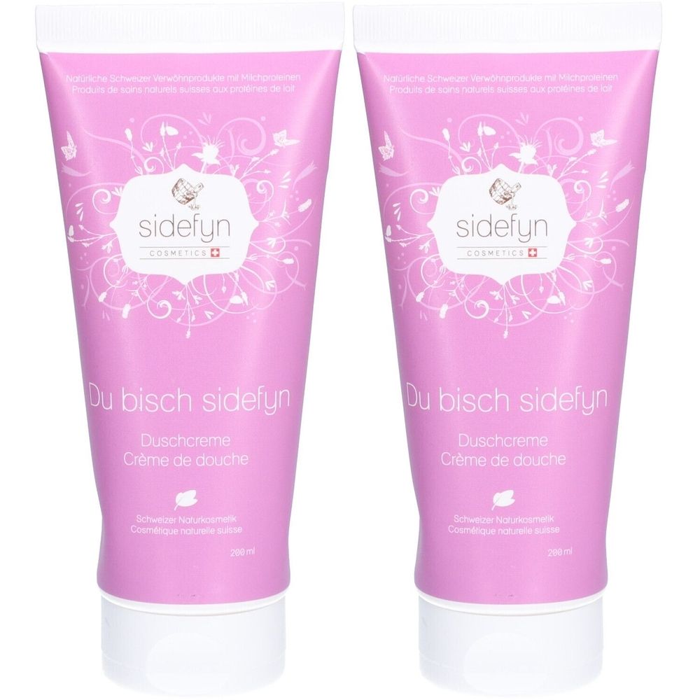 Twee roze tubes douchecrème met witte opdruk. Opschrift: "sidefyn", "Du bisch sidefyn", "Duschcreme", "Crème de douche".