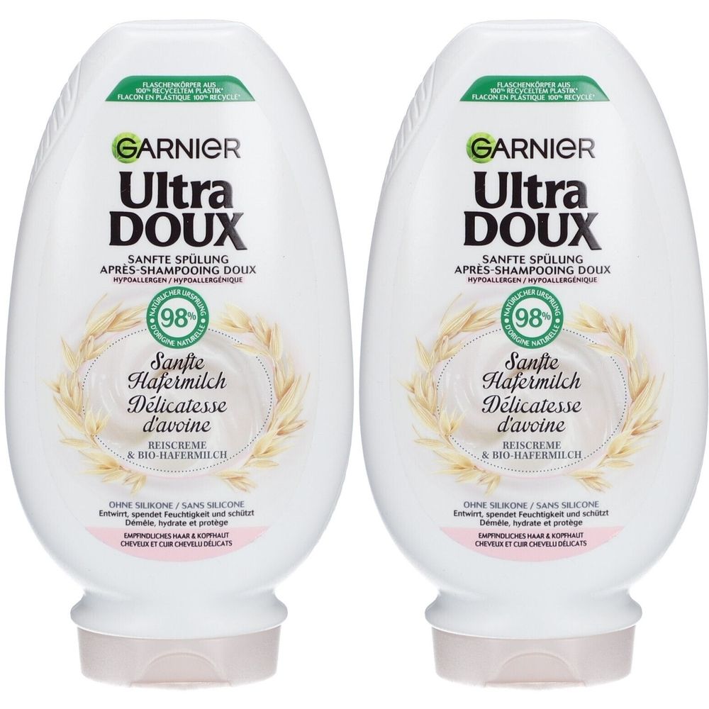 Twee witte flessen Garnier Ultra Doux Sanfte Spülung. Opschrift: Sanfte Hafermilch, 98%. Ovale flessen met lichtroze dop.