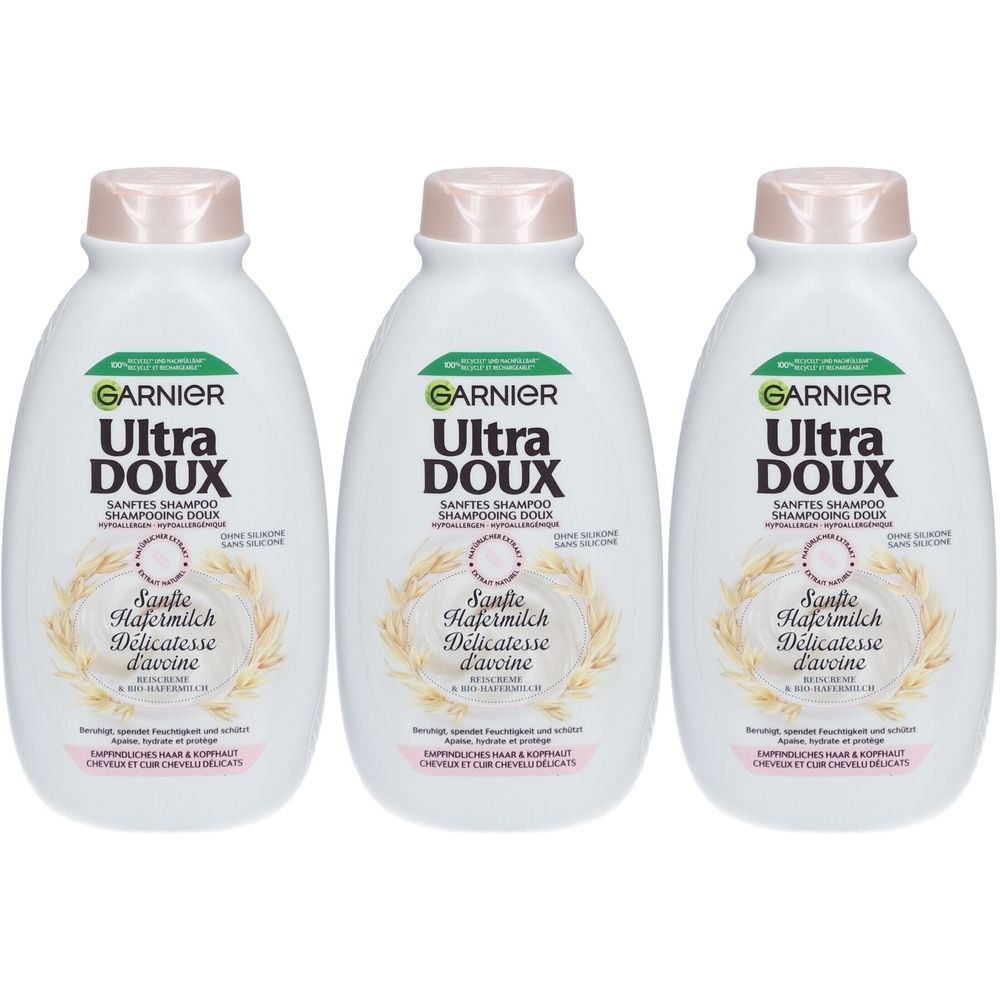 Trois flacons de shampooing blancs avec des bouchons roses. Chaque flacon porte les inscriptions "GARNIER Ultra DOUX" et "Sanfte Hafermilch Délicatesse d'avoine".