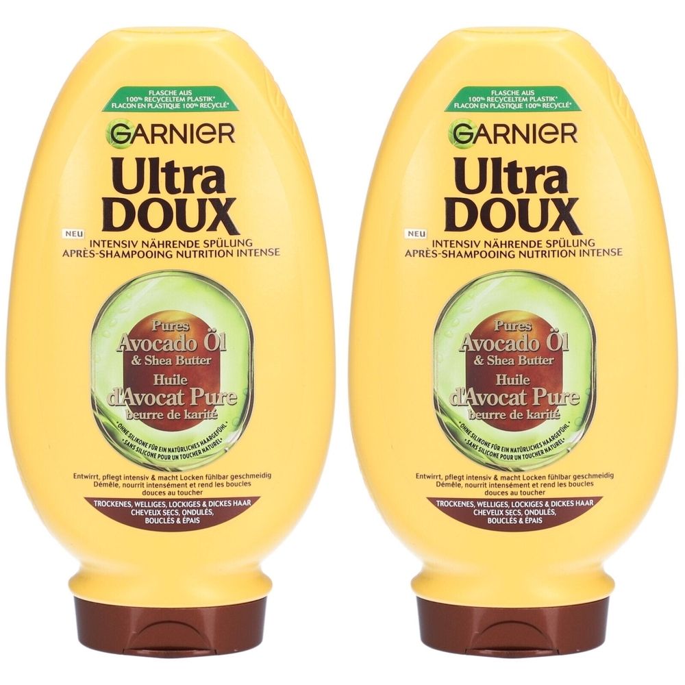 Twee gele flessen GARNIER Ultra Doux conditioner. Opschrift: Intensief voedende conditioner met avocado-olie & shea butter. Voor droog, golvend haar.