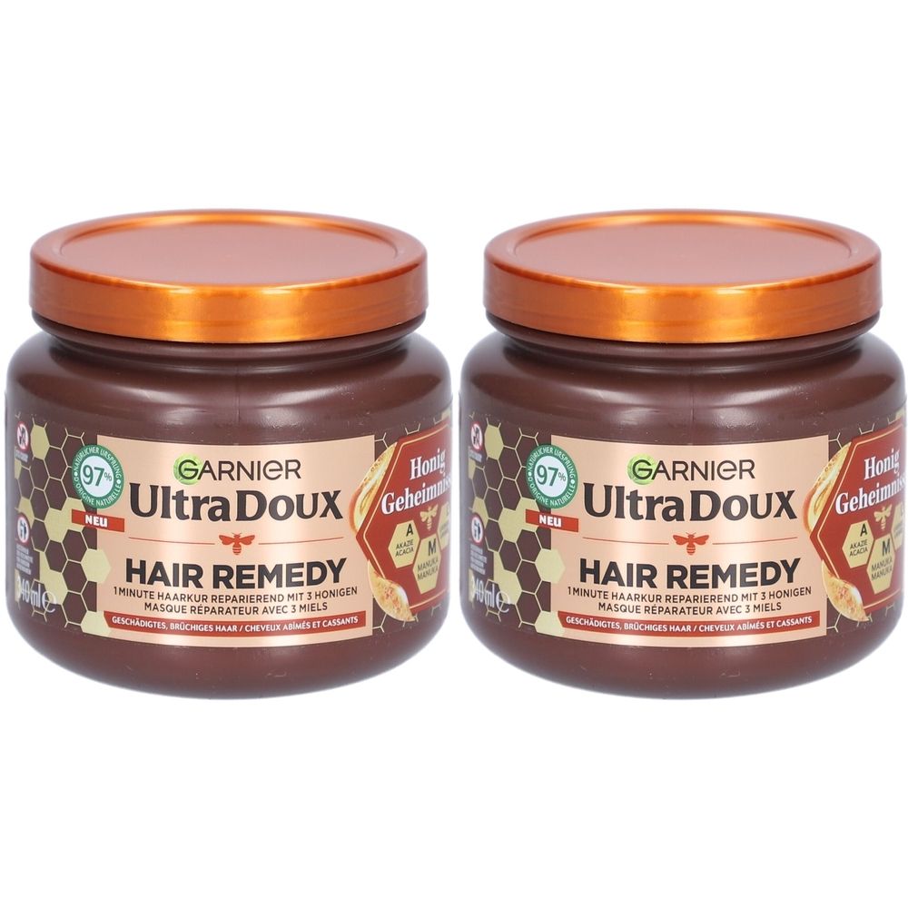 Deux masques Garnier Ultra Doux Hair Remedy au miel. Pots marron avec couvercles orange.