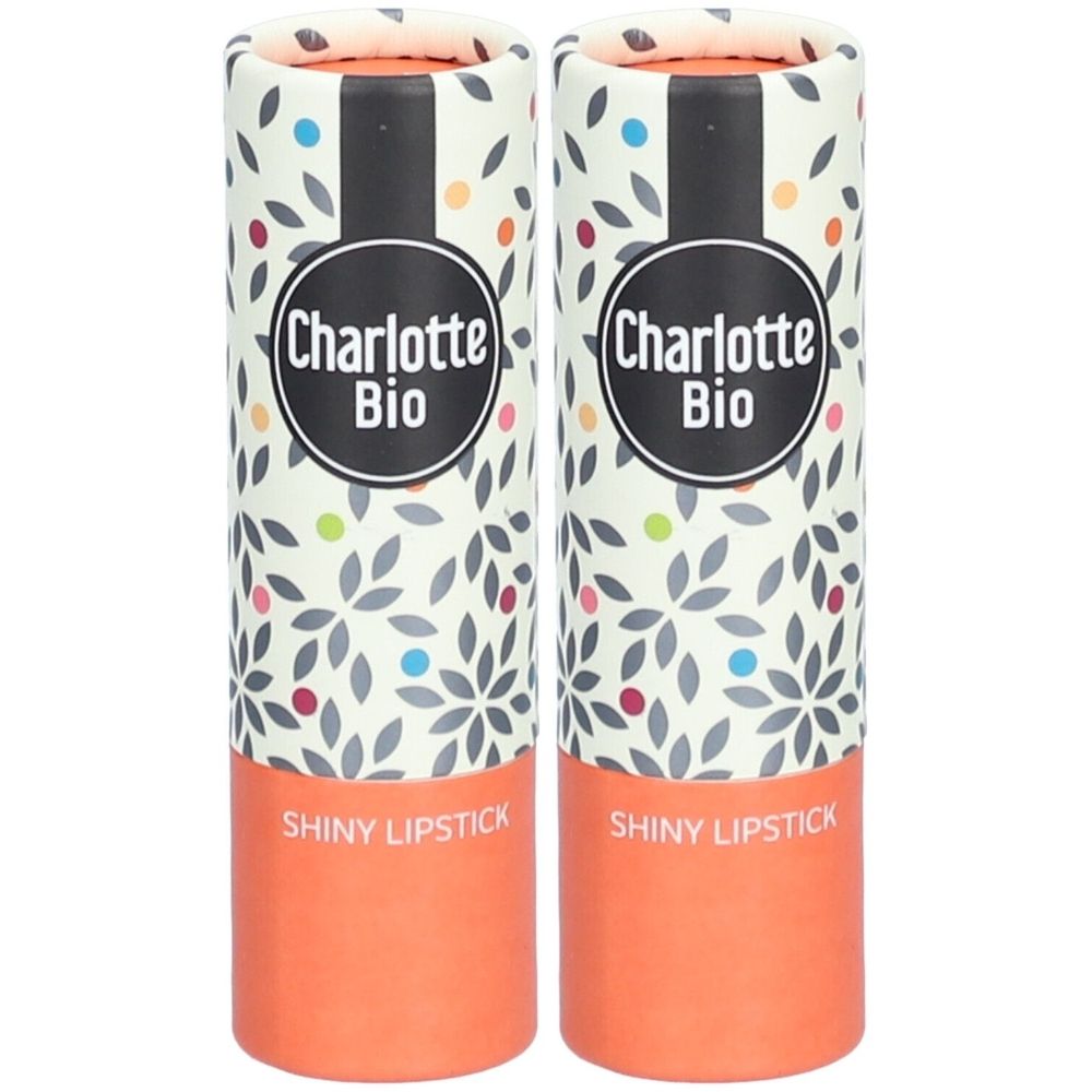 Twee lipsticks in cilindrische verpakkingen. Opschrift "Charlotte Bio" en "Shiny Lipstick". Verpakking met bloemmotief.