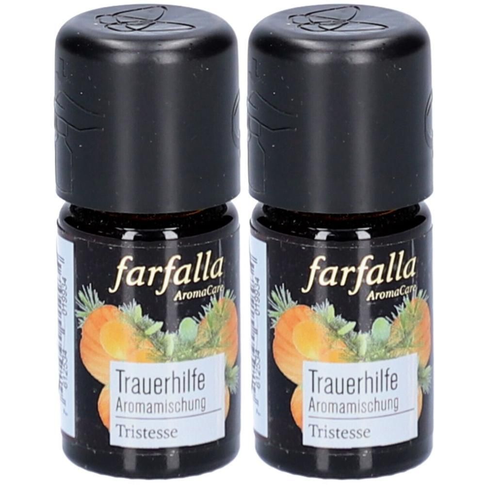 Twee kleine bruine flesjes met zwarte dop. Opschrift: farfalla AromaCare, Trauerhilfe Aromamischung, Tristesse.