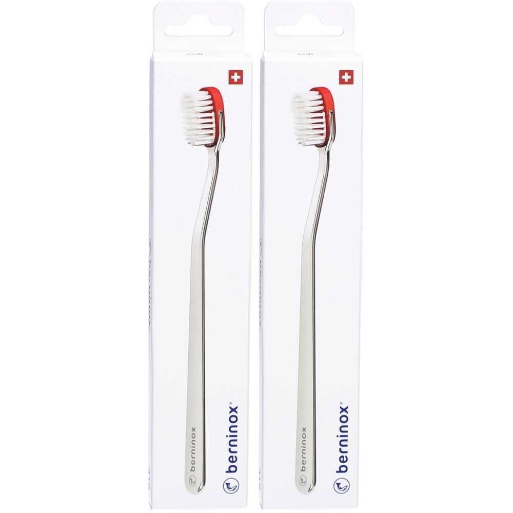 Deux brosses à dents dans leur emballage. Tête blanche bordée de rouge, manche argenté. Marque : berninox, croix suisse.