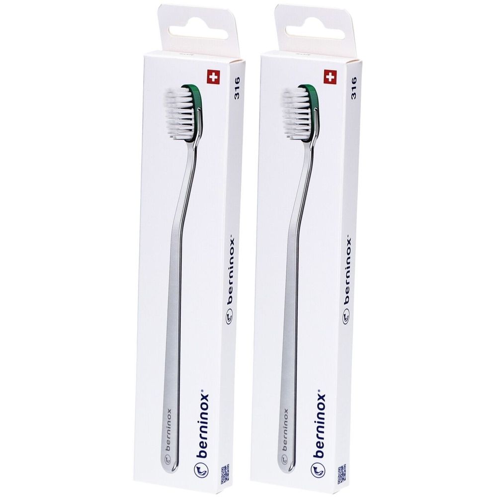 Deux brosses à dents dans des emballages blancs. Les brosses ont un manche argenté et une tête verte. Le mot "berninox" est visible.