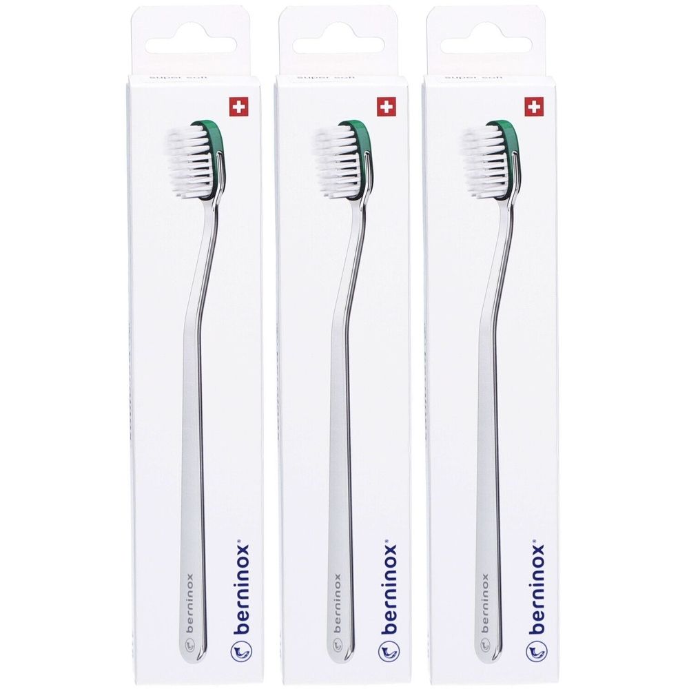 Trois brosses à dents emballées. Soies blanches, tête verte, manche argenté. Croix suisse. Marque : berninox.